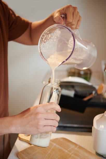 Man Pouring Protein Shake in Bottle