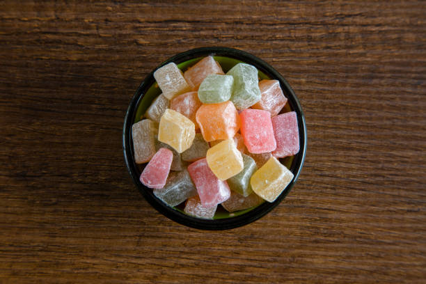 istock Multi colored Turkish delight in a bowl on a wooden background 1392078143