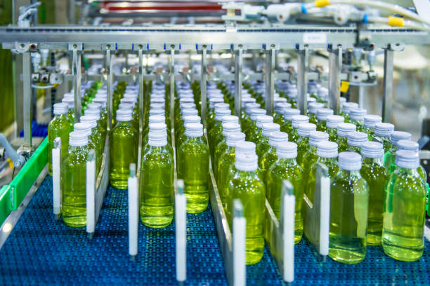 istock Transfer of glass bottles on automatic conveyor systems Industrial automation for packaging 1392081096