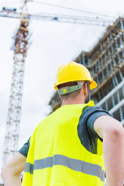 istock Building Construction Worker Engeeneer Looking To The Building Construcion He Is Working On 1392081513