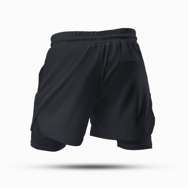 istock Mockup of men's textured black shorts with compression lining, 3D rendering, back view, isolated on background. 1392083032