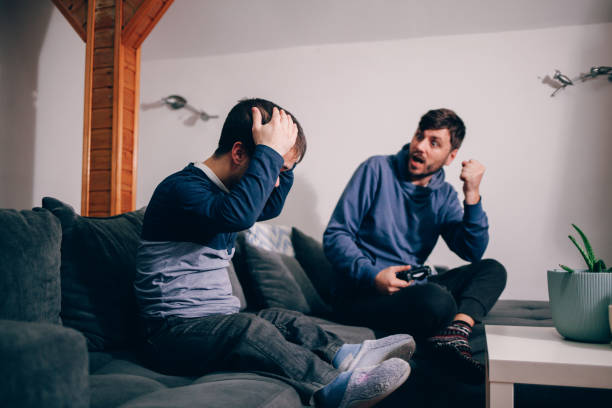 istock Excited friends playing playstation 1392083660