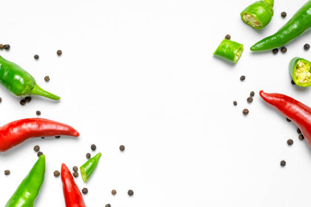 Hot red and green fresh chili peppers, dry black peppercorns on white background flat lay top view. Seasoning for dish, spicy spices for cooking, cayenne pepper, food. Creative layout, chili pattern Hot red and green fresh chili peppers, dry black peppercorns on white background flat lay top view. Seasoning for dish, spicy spices for cooking, cayenne pepper, food. Creative layout, chili pattern. chili pepper pattern stock pictures, royalty-free photos & images