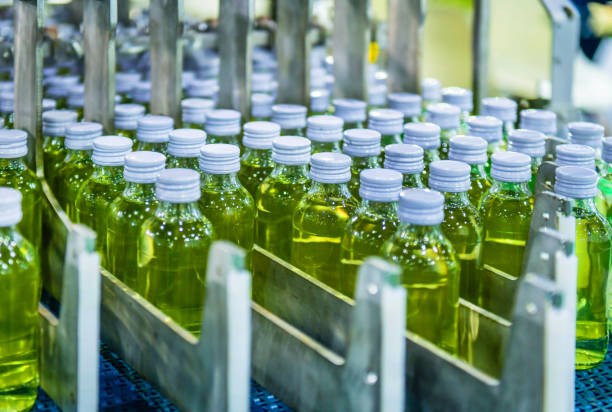 Transfer of glass bottles on automatic conveyor systems Industrial automation for packaging