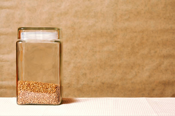 Bank with buckwheat on the kitchen table, still life. template with a copy space for advertisement text