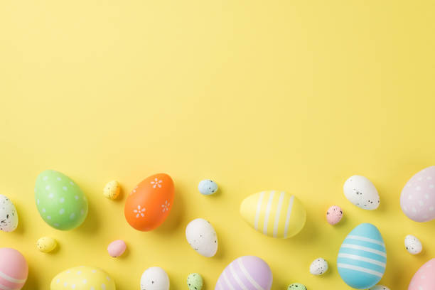 istock Top view of multicolored Easter eggs and quail ones situated on the isolated yellow background copyspace 1392085102