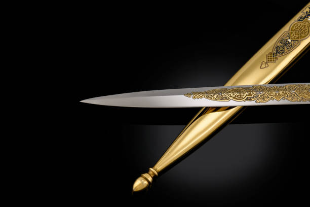 collectible silver dagger with scabbard on black souvenir collectible silver gold dagger cutlass with scabbard, with metal engraving, on black background. Luxury weapons with traditional patterns in medieval vintage style. butcher knife scabbard stock pictures, royalty-free photos & images