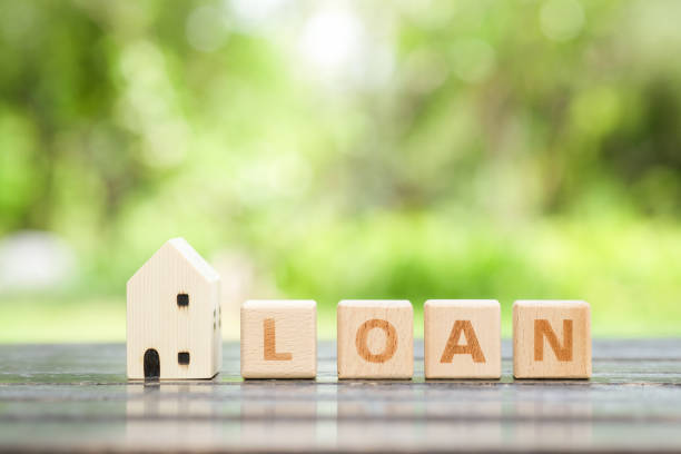 istock Wood block word LOAN and house model. 1392086791