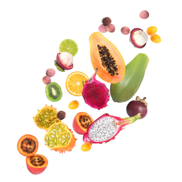 verschiedene leckere exotische früchte, die auf weißem hintergrund fliegen - kawani fruit stock-fotos und bilder
