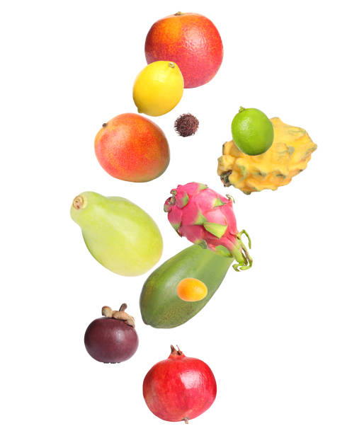 istock Different tasty exotic fruits flying on white background 1392090722