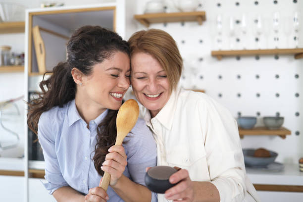 istock Mother and daughter having fun together while dancing in the kitchen 1392090866