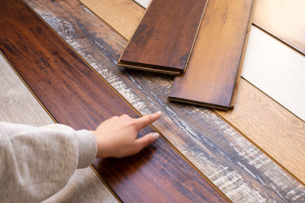 istock Woman is choosing a new laminate in a construction store. 1392091110