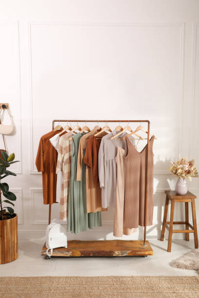 istock Stylish clothes hanging on rack in dressing room. Interior design 1392091703