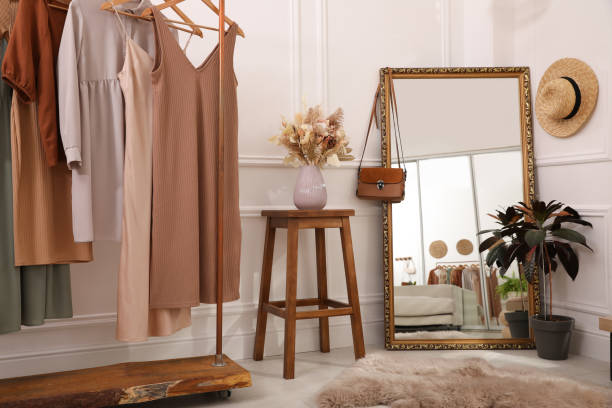 istock Dressing room interior with large mirror and stylish clothes 1392091707