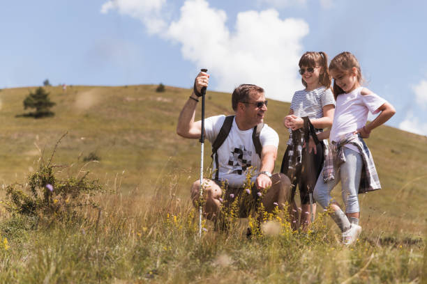 istock Happy father introducing his children to herbs on a mountain 1392092263