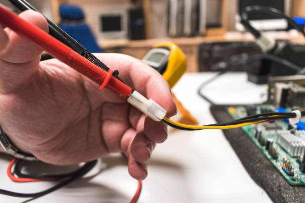 istock Detail of a multimeter being used by a technical IT on a computer motherboard 1392093051