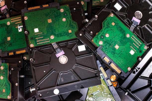 istock Mechanical hard drives stacked in a box for recycling 1392093076