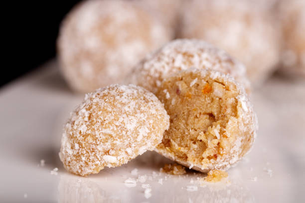 istock Beautiful sweets with coconut on a white plate on a black background 1392093396