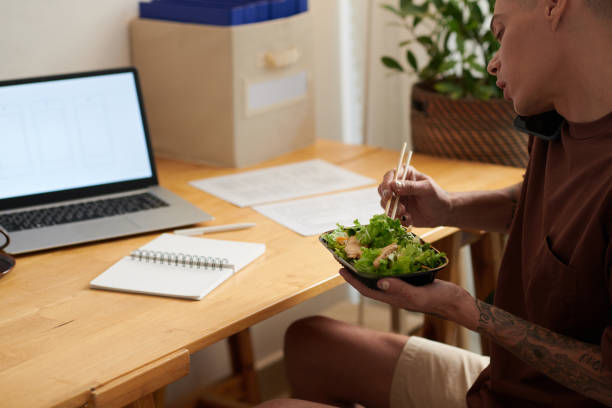 istock Man Eating Salad for Lunch 1392093448