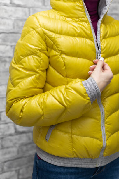 istock a woman zips up her jacket around her throat 1392096109