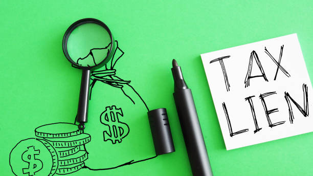 A pen used to draw money with note saying tax lien