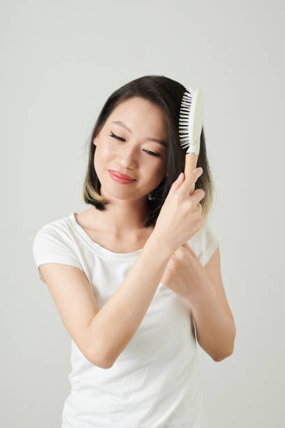 istock Woman Enjoying Brushing Hair 1392097794