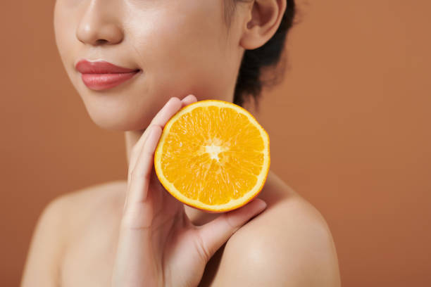 istock Woman Holding Cut Orange 1392097857