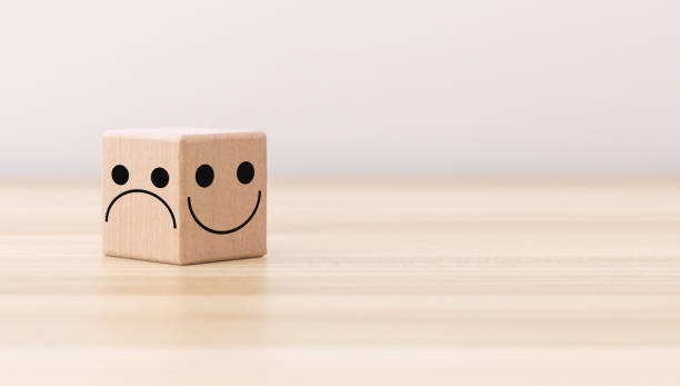 istock smiley face and sad face icon on wood cube, Service rating, satisfaction concept, copy space. 1392097880
