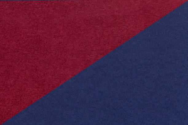istock Texture of craft navy blue and dark red paper background, half two colors, macro. Structure of wine kraft cardboard. 1392098637