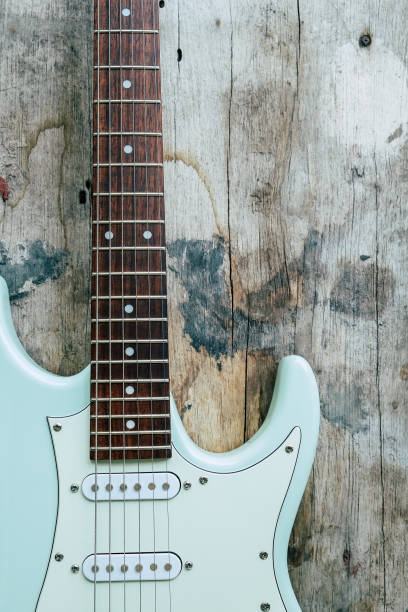 istock Mint Green Electric Guitar on a wood background. 1392098878
