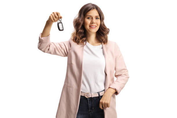 istock Young woman holding car keys and smiling 1392101091
