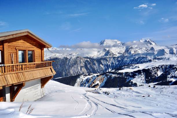 Winter scenery with wooden hut in French alps by winter. Beautiful ski resort view with a small wooden hut in front of Mont Blanc mountain courchevel stock pictures, royalty-free photos & images
