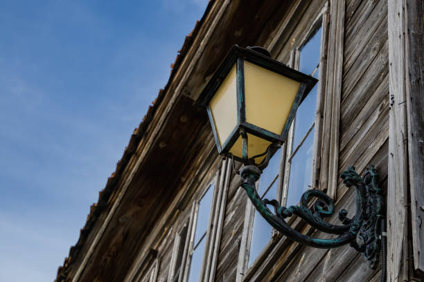 istock Street lamp with patterns on an old wooden house 1392101826