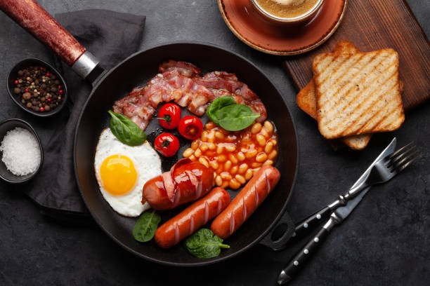 istock English breakfast with fried eggs, beans, bacon and sausages 1392101870