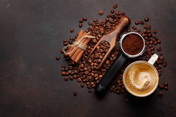 istock Roasted coffee beans and ground coffee in filter holder 1392103780