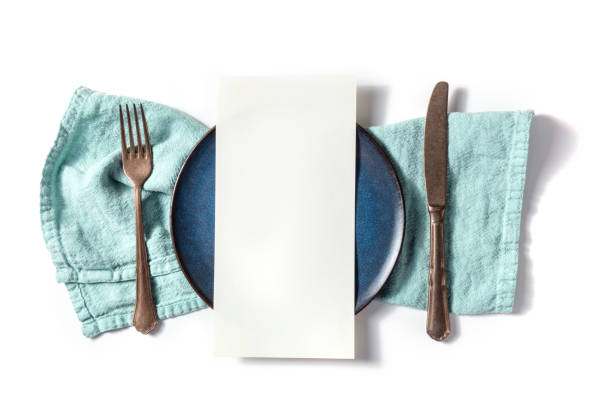 istock Dinner menu or invitation concept. A piece of paper on a set table 1392110708