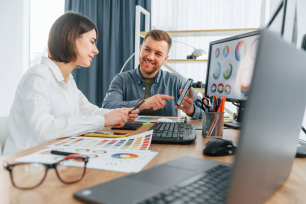istock Talking and creating content. Two designers working together in the office 1392112105