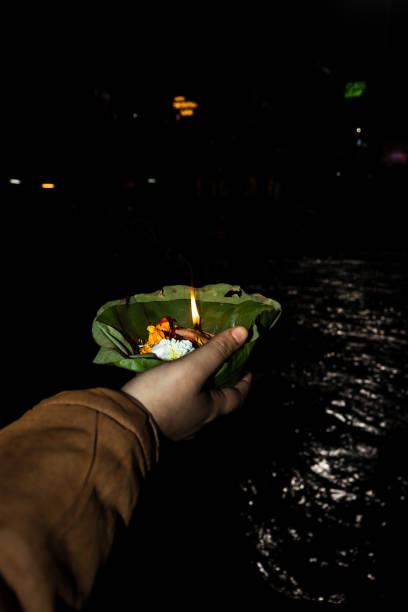 istock devotee holding aarti flower pot for ganges river evening prayer at night 1392112161