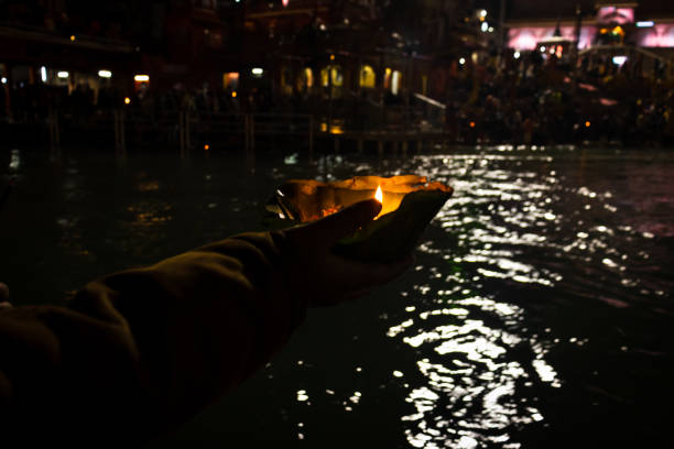 istock devotee holding aarti flower pot for ganges river evening prayer at night 1392112174