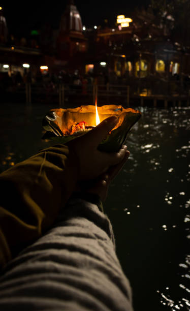 istock devotee holding aarti flower pot for ganges river evening prayer at night 1392112182