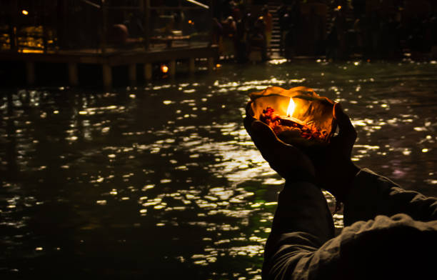 istock devotee holding aarti flower pot for ganges river evening prayer at night 1392112189