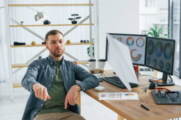 istock Throwing paper plane. Male designer working in the office by using PC 1392112231
