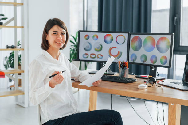 istock With paper. Female designer working in the office by using PC 1392112254