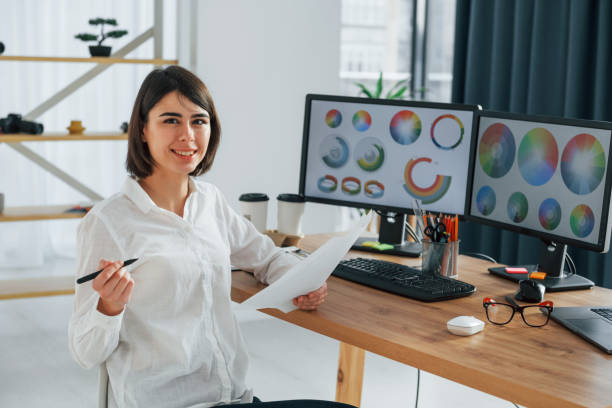 istock With paper. Female designer working in the office by using PC 1392112255