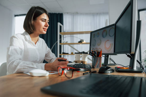istock Looking at display. Female designer working in the office by using PC 1392112269