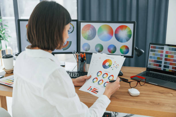 istock With paper. Female designer working in the office by using PC 1392112350
