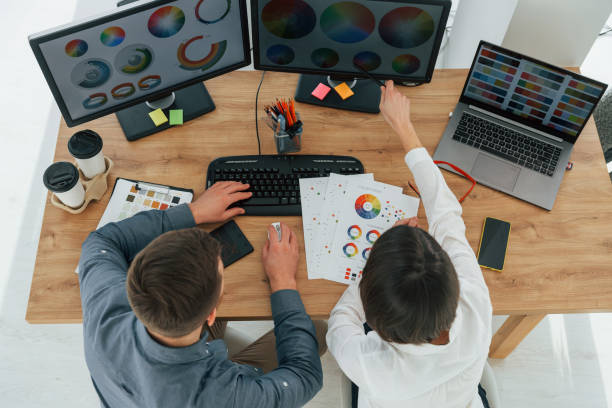 istock Top view. Two designers working together in the office 1392112372