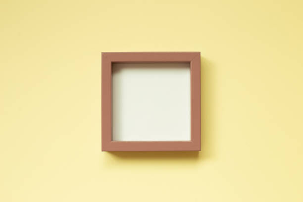 istock Pink picture frame on yellow background. top view, copy space 1392114578