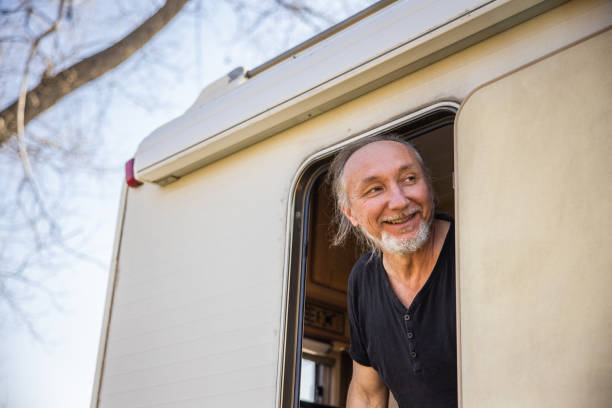 istock Caucasian man getting out from the camper van 1392118540
