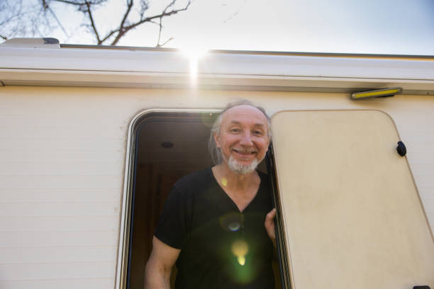 istock Carefree Caucasian man getting out from the camper van 1392118542